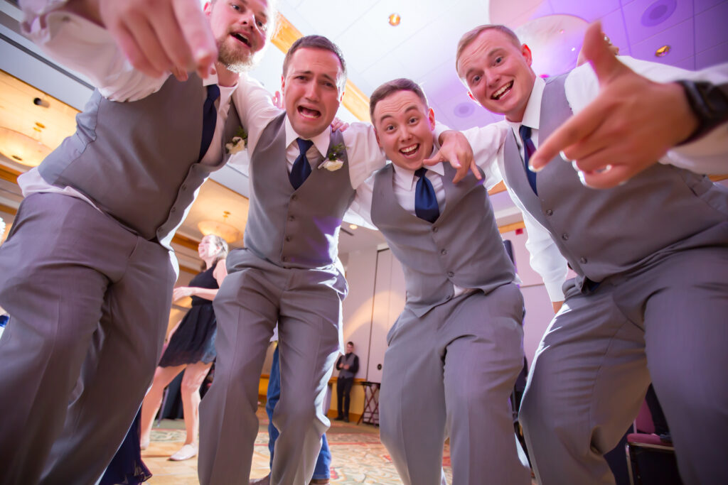 Groomsmen dancing at a wedding to the music from the DJ